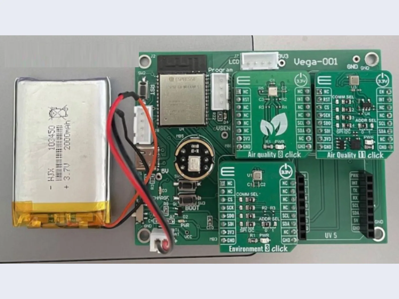 The MVP v1 sensing board: an ESP32 module with Air Quality 8, Air Quality 11 and Environment 3 click boards, a UV 5 slot and a 2000 mAh lithium cell alongside